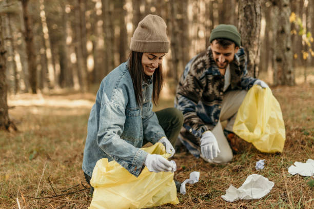 istock Picking up plastic bottles and trash in the woods 2188406429