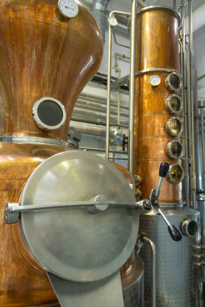 istock Distillate production process in copper distillation unit. Cpper vacuum still for distillation performed under reduced pressure for gin production. 2188409251