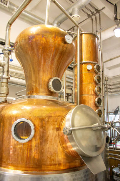 istock Distillate production process in copper distillation unit. Cpper vacuum still for distillation performed under reduced pressure for gin production. 2188409270