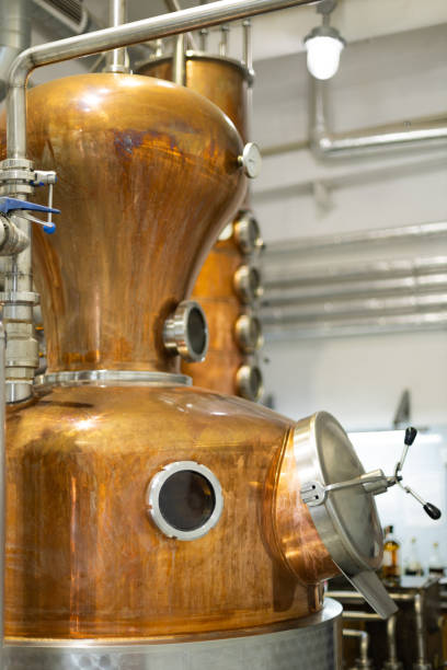 istock Distillate production process in copper distillation unit. Cpper vacuum still for distillation performed under reduced pressure for gin production. 2188409316