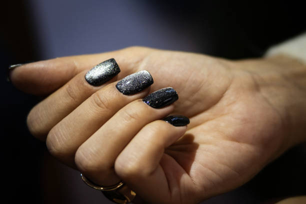 Beautiful young lady hands with bright nail art.