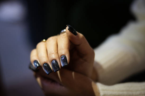 Beautiful young lady hands with bright nail art.