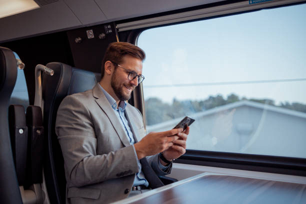 istock On-the-Go Communication: Traveler Texting While Traveling by Train 2188411479