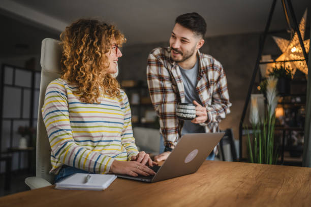istock Husband take care of his wife while she work from home 2188411809