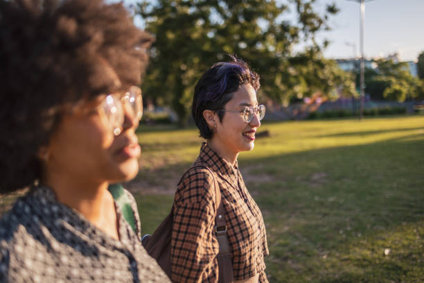 istock Two friends enjoying a walk in the park during sunny afternoon 2188413069