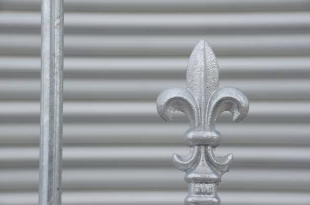 An element of wrought iron decor for the exterior decoration of buildings. Grey background of wrought iron decoration on a grey concrete wall.