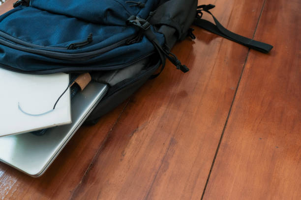 istock Blue backpack with books, notepad and laptop for student or working on the wooden table 2188416854