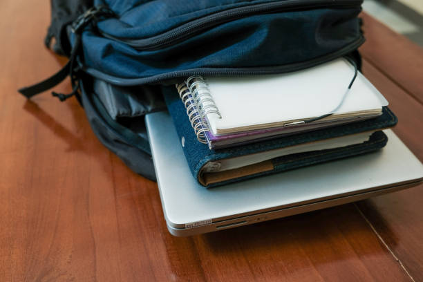 istock Blue backpack with books and laptop for student or working on the wooden table 2188416921