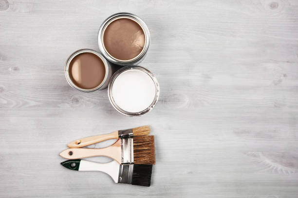 istock Artistic setup with open paint cans and brushes on a wooden surface 2188417706