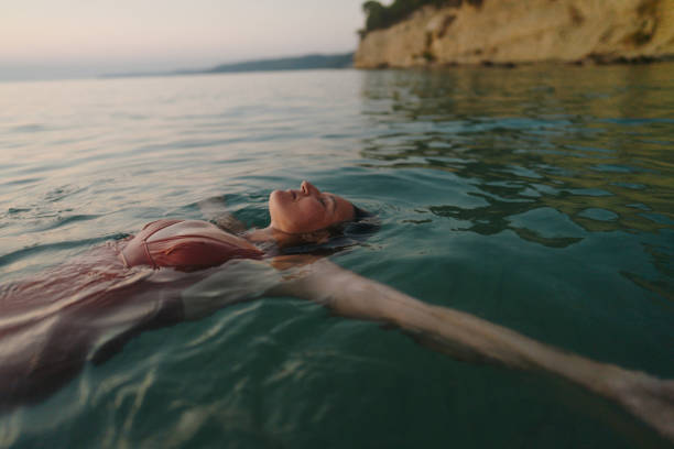 Photo of a mid adult woman swimming in the calm sea water