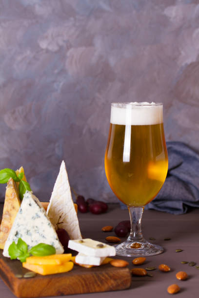 istock Glass of beer and cheese plate 2188424815