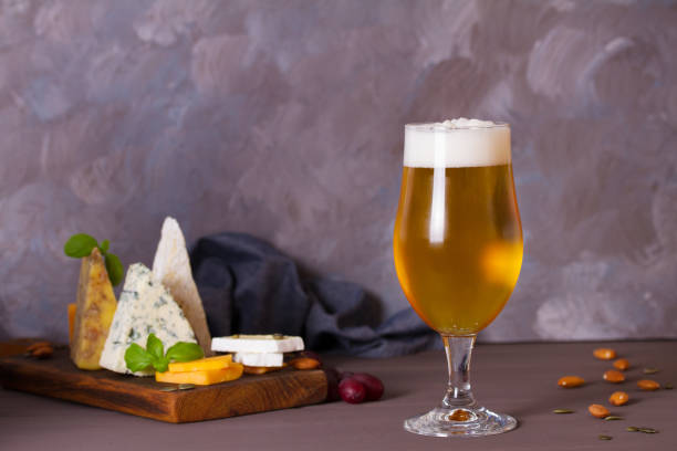 istock Glass of beer and cheese plate 2188424818