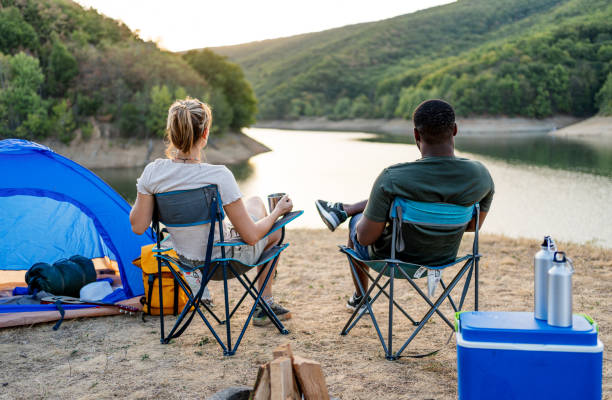 istock Friends enjoying camping by the lake together 2188424893