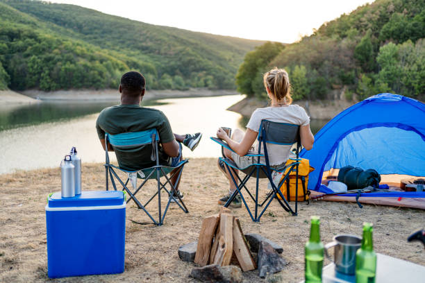 istock Friends enjoying camping by the lake together 2188426048