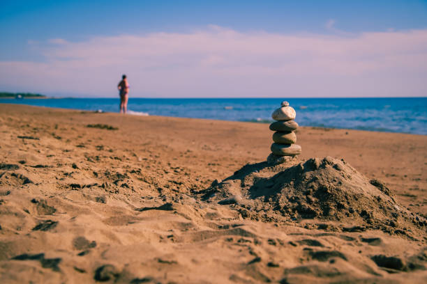 Making rock balancing art on the beach from sea stones