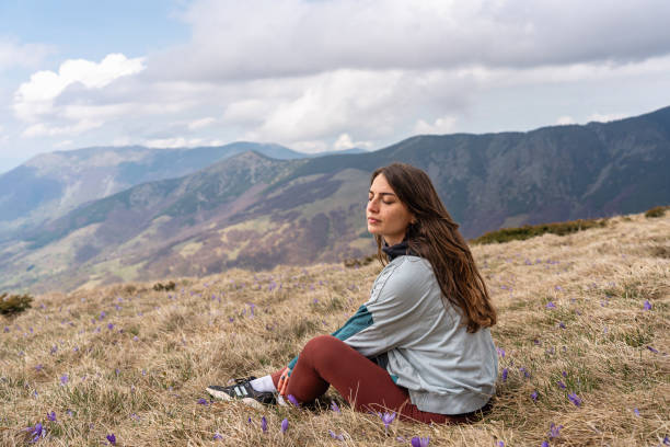 istock A woman rests on the mountain she climbed during her hiking 2188429530