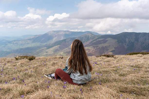 istock A woman rests on the mountain she climbed during her hiking 2188430046