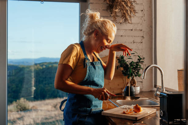 istock Senior woman cutting up onion in kitchen. 2188431038