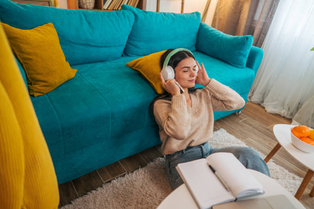 istock Young woman using music streaming services on her phone 2188431102