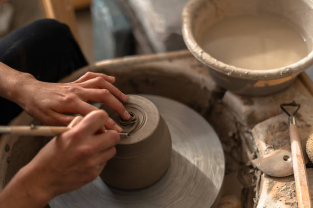 istock Ceramist using pottery wheel creating clay vessel in workshop 2188433645