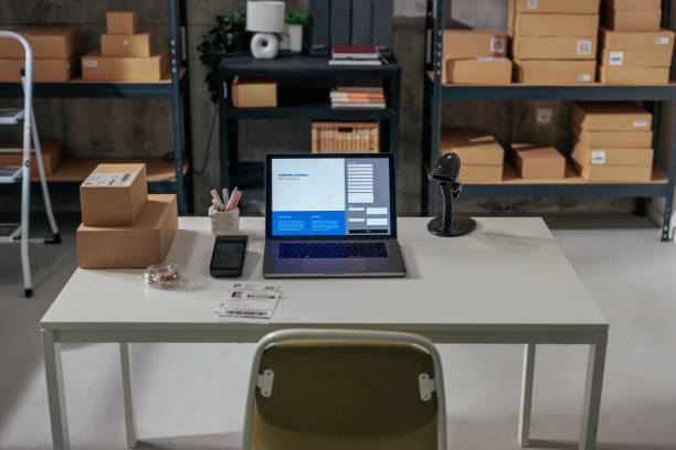istock Office desk with laptop and warehouse view 2188437770