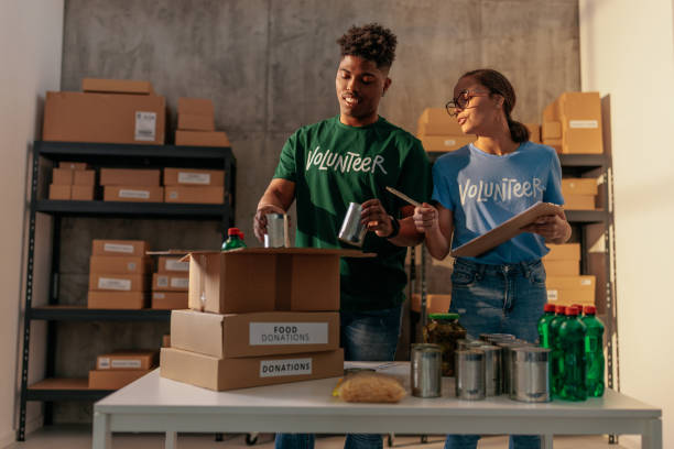 istock Couple of volunteers sorting through donations 2188437793