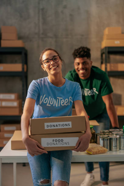 istock Volunteers holding donation food boxes 2188437800