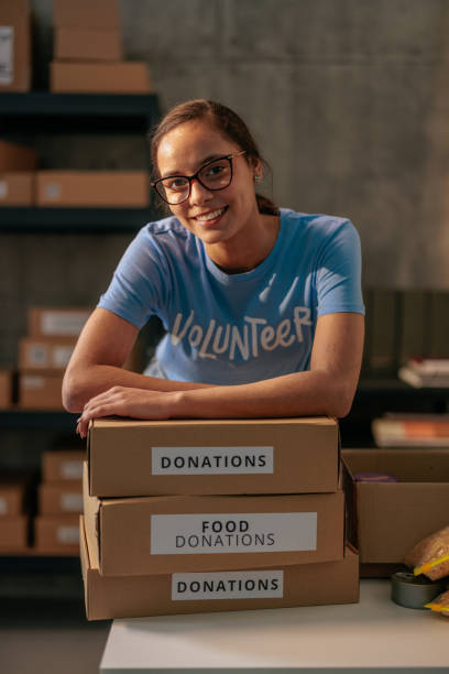 istock Volunteer with food donation boxes 2188437803