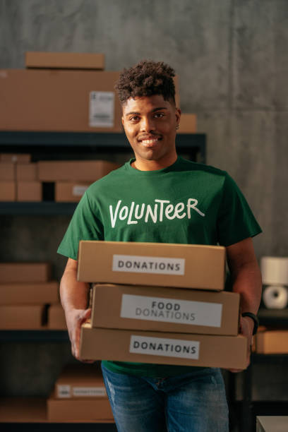 istock Male volunteer carrying donation boxes 2188437810