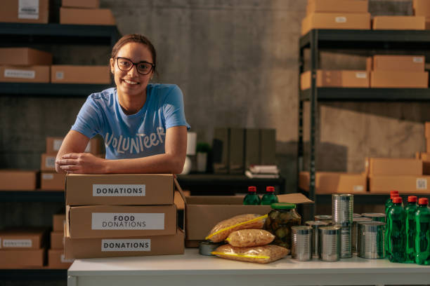 istock Volunteer sorting food donations in warehouse 2188437815