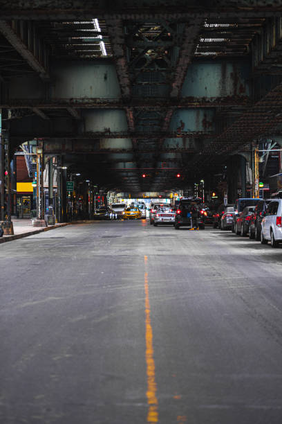 istock Urban Street Scene Under Elevated Train Tracks Featuring City Traffic and Architectural Elements in a Vibrant Metropolitan Setting 2188439976