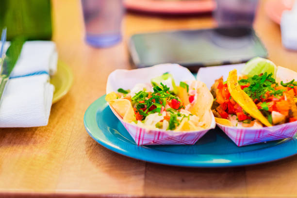 Authentic Mexican Street Tacos with Fresh Ingredients, Cilantro, and Lime Garnish on a Vibrant Plate, Perfect for a Culinary Presentation or a Food Blog Feature with a Focus on Mexican Cuisine