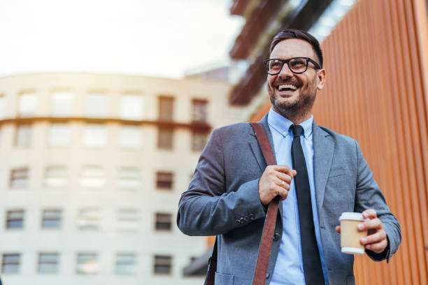istock Confident Businessman Holding Coffee Outdoors in Urban Setting 2188441928