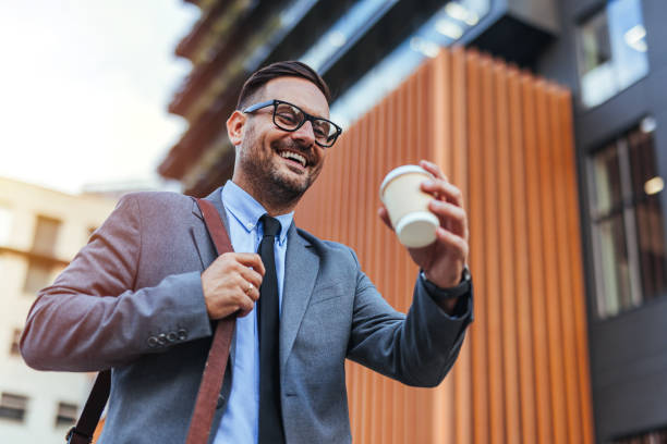 istock Confident Businessman Walking with Coffee in Urban Setting 2188441930