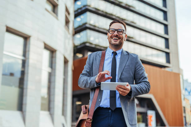 istock Confident Businessman Using Tablet Outdoors Near Office Building 2188441932