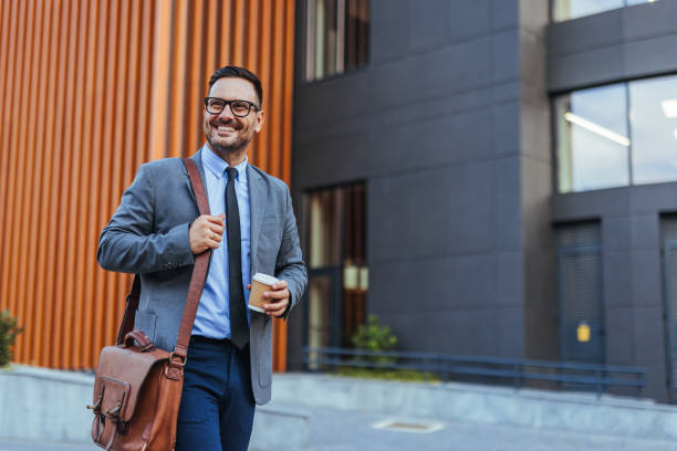 istock Confident Businessman With Coffee Walking Outside Office Building 2188441941