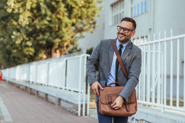 istock Confident Businessman Walking with Leather Briefcase Outdoors 2188441951