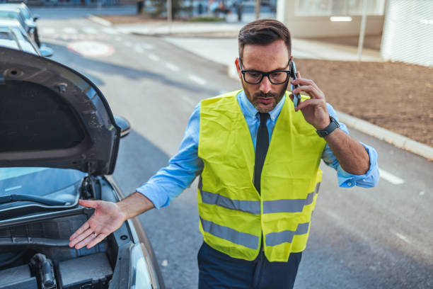 istock Man in Safety Vest Calling for Roadside Assistance 2188441964