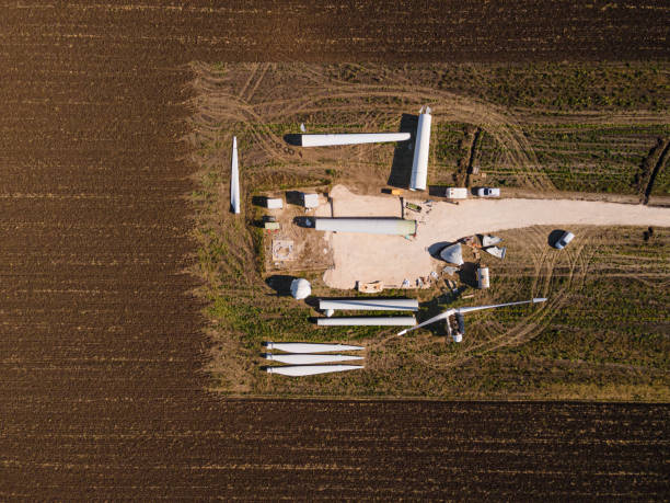 Eco energy concept. Aerial view of wind turbine parts ready for installation on site. Challenges & impact of renewable energy industry  in the Energy sector.