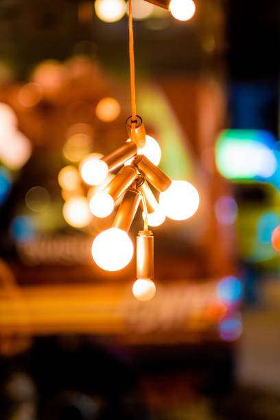 istock Golden Retro Light Bulbs Hanging in Warm Glowing Ambience with Blurred Bokeh Background Creating Cozy Vintage Atmosphere Perfect for Interior Design Ideas and Creative Lighting Inspirations 2188448002