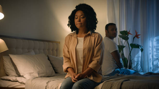 istock Couple family relationship problem conflict misunderstanding quarrel silence avoid separated African American woman wife girlfriend suffer sad husband boyfriend abuse frustrated sitting on bed night 2188450399