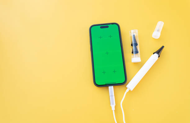 istock Mockup Ear Scope For Wax Removal Tool and Smartphone with Chroma Key Green Screen. Digital Otoscope, Earwax Cleaner With Gyroscope, Camera, Light. Cleaning Ears Device Connected to Phone. Copy Space, 2188451127