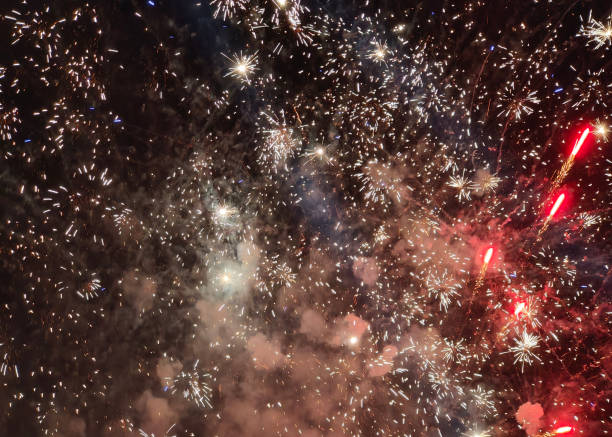 Close-up shot of explosion New Year Fireworks in a dark sky. Concept: fireworks display, Bali New Year celebration, vibrant colors, night sky, festive event, dazzling lights, holiday cheer, explosive patterns, celebration joy, magical moment, music festival, wedding celebration, chinese new year, abstract fireworks sparks
