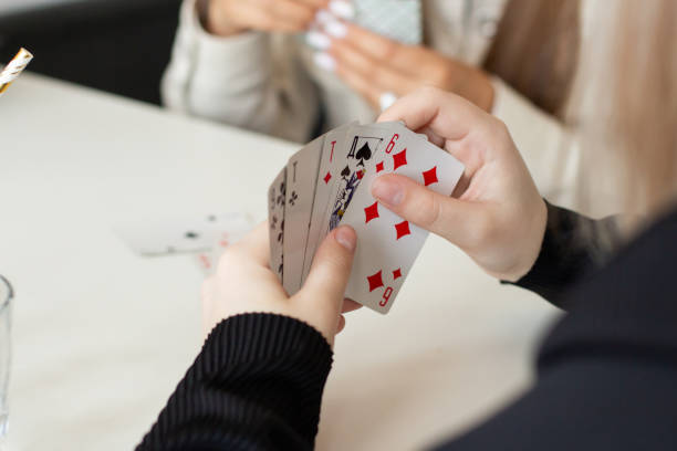 istock Three girls playing game cards at home 2188452370
