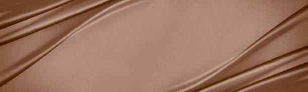 istock Black dark light pastel dusty pale soft chocolate coffee brown beige nude abstract background. Silk satin fabric. Curtain drapery line wave. Mocha moose color 2025.Flat lay, top view table.Wide banner. 2188453375