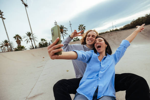 istock Young couple taking a selfie in a skatepark 2188453690