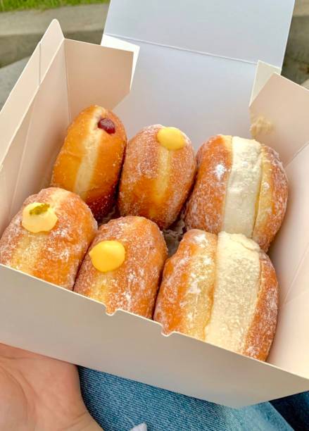 istock Bomboloni, soft Italian doughnuts filled with creamy custard or jam, dusted with powdered sugar. Fluffy and indulgent, they’re a perfect sweet treat, enjoyed fresh and warm with every bite. 2188454047