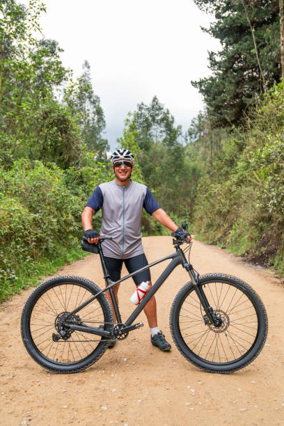 istock Man mountain biking and standing next to his bicycle 2188455601