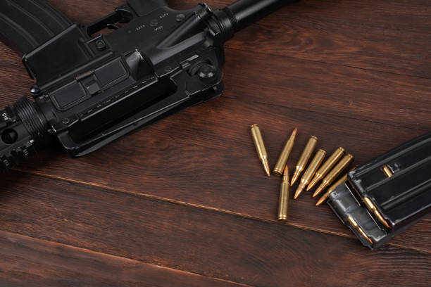 Rifle and Ammunition with magazine on wooden table background
