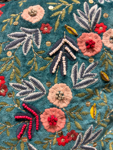 istock A blue and green floral patterned fabric with red flowers embroidered on it 2188458486